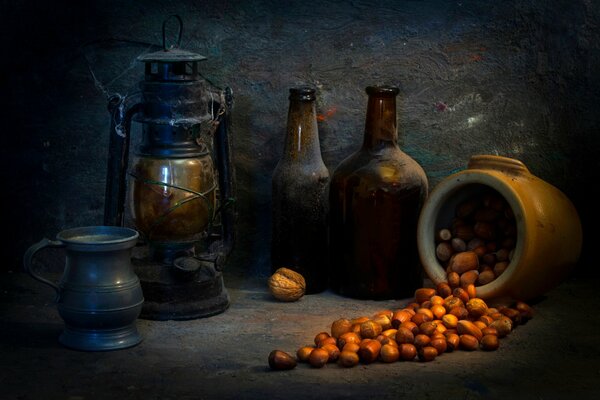 Still life with ancient utensils in a spider web and scattered nuts