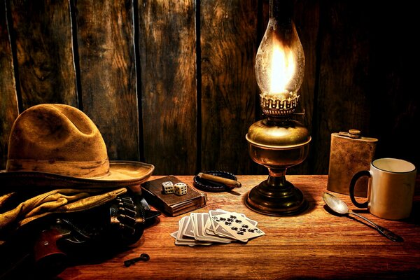 Still life with a cowboy hat and a kerosene lamp