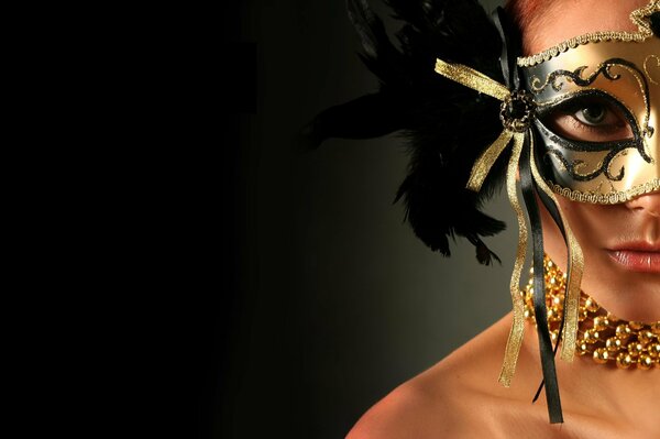 Brunette in a theatrical mask on a black background