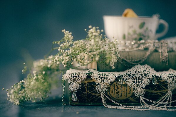 Books about fairy tales in lace on the background of a cup