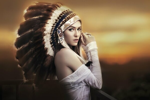 A girl in white clothes and Indian feathers on her head
