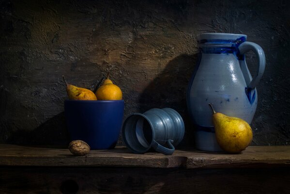 Wooden table with pears and blue dishes