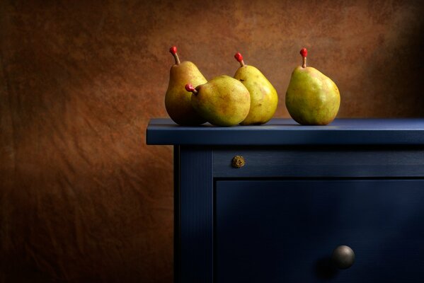 Pears on a blue chest of drawers