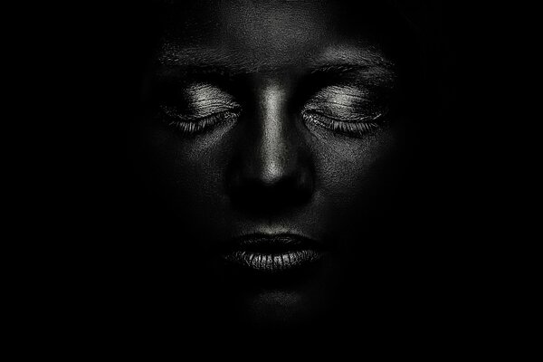 Dark-skinned girl with white eyelashes on a black background