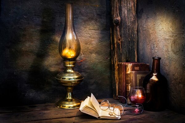 A book with glasses on the background of candles and wine