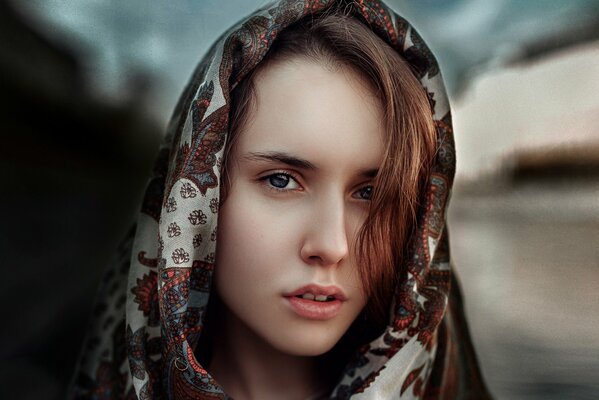 Photo portrait of a girl in a scarf in the Russian style