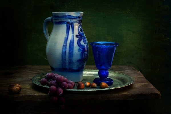 Composition for still life. Grapes, nuts and a glass