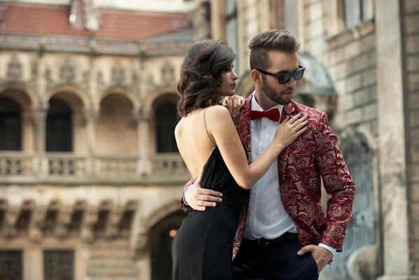 A couple of young people on the background of an old building