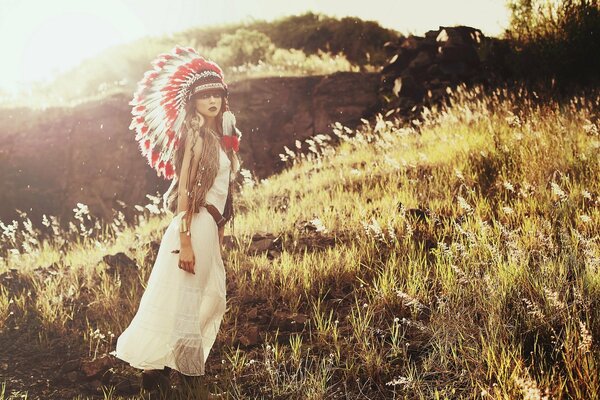 A girl with feathers in the field