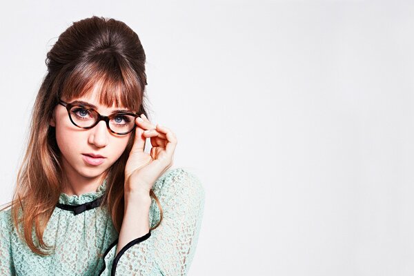 Zoey Kazan with a retro hairstyle in round glasses