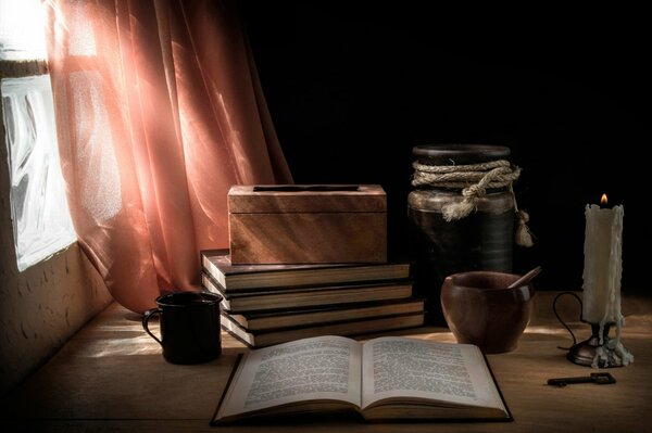 Still life books, candle and curtains