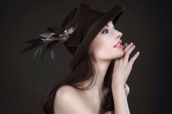 Photo of a girl in a hat with a feather