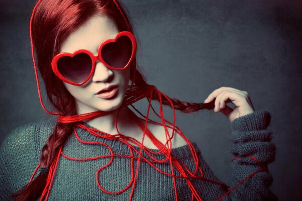 Photo of a girl with fiery hair wearing glasses