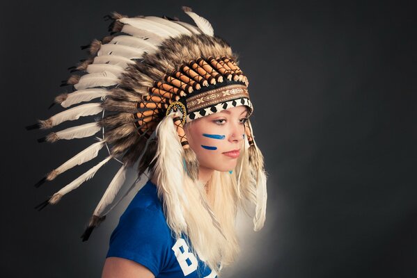 A girl with a headdress with feathers