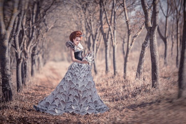 A girl in a newspaper dress in the garden