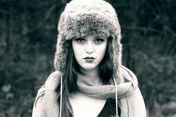 A girl in a winter hat and with a scarf