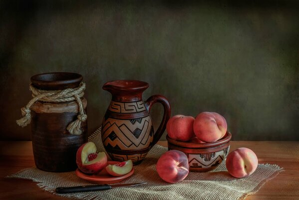 Jug and juicy peaches. Still-life