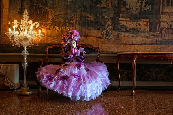 The girl is sitting in the palace in a beautiful dress