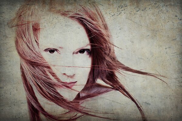 Portrait of a red-haired girl in the wind