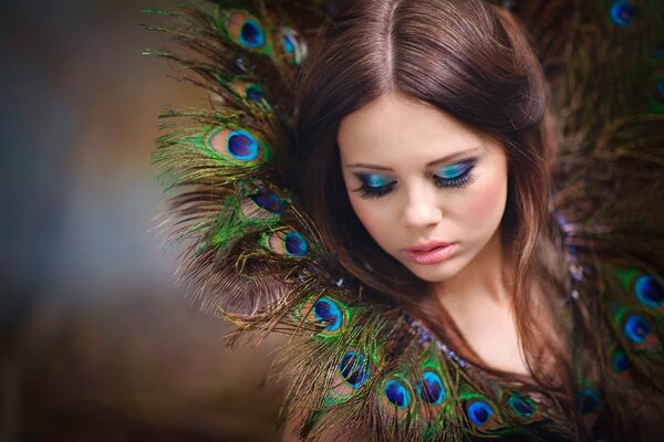 Portrait of a girl in peacock feathers