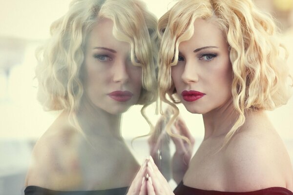 Reflection of a blonde with red lips