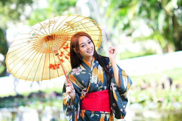 Девушка в азиатском стиле с зонтом на руках , нарядная