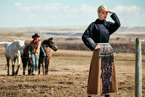 Photo session in the style of the Wild West. Cowboy, horses and girl