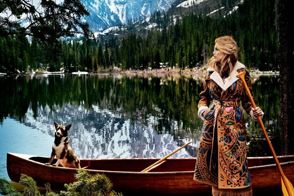 Chica con una paleta en un barco con un perro