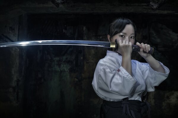 Asian girl with a katana sword in her hands