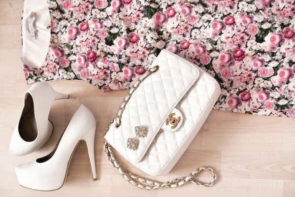 Stylish women s handbag and white shoes complement each other perfectly