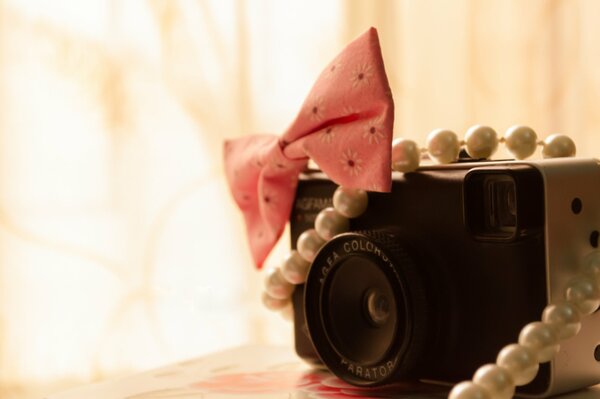 A camera with beads and diamonds in the frame