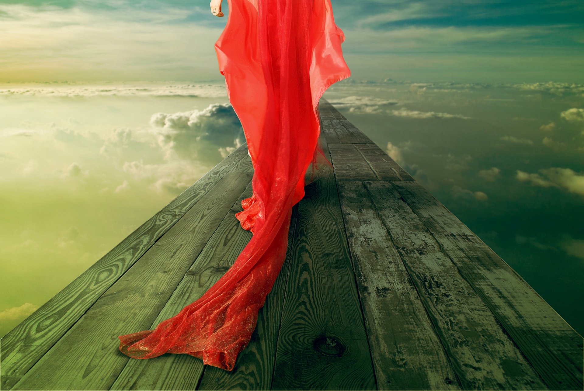 the red girl in a red dress flex cable bridge sky clouds ring