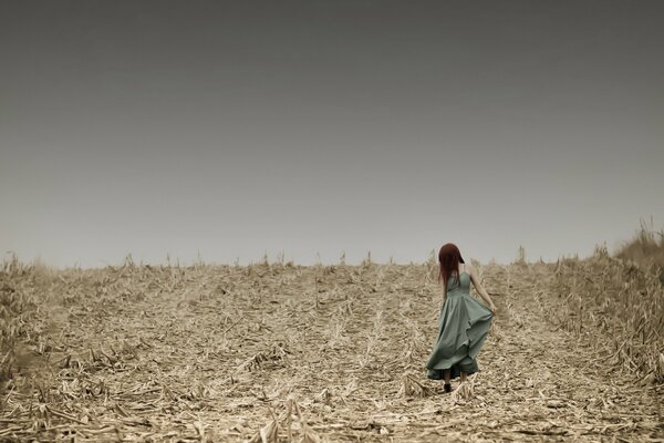 Girl in a long dress in the field