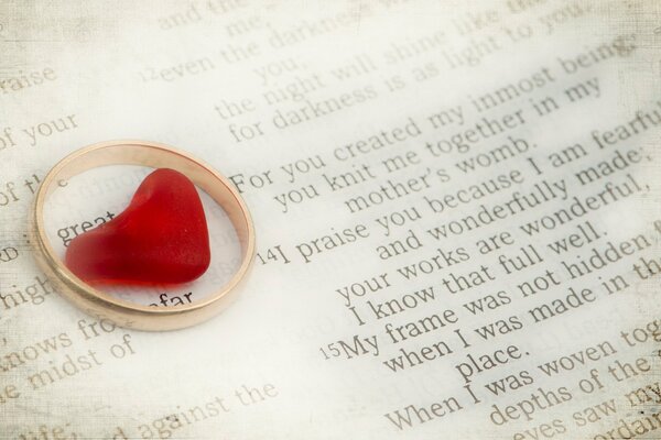 Red hearts in a ring on the background of English text