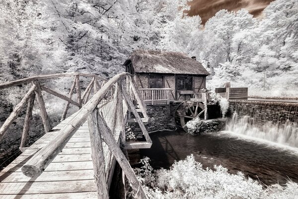 Paesaggio invernale con casa attraverso il ponte