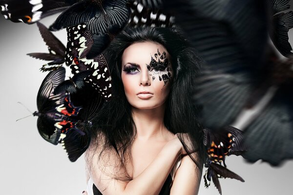 Photo of a girl with unusual makeup and butterflies