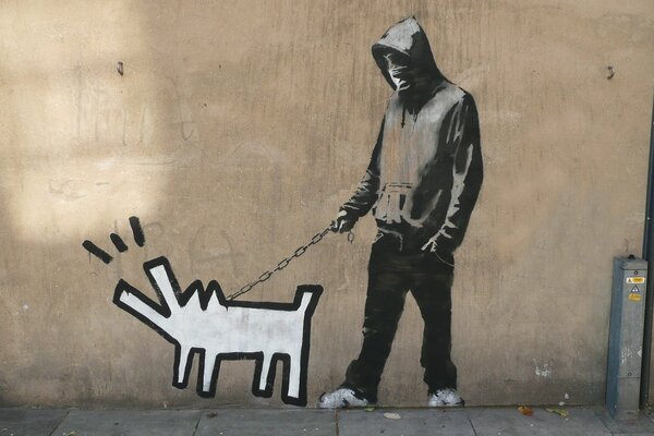 Il ragazzo cammina con il cane di Banksy e lei abbaia