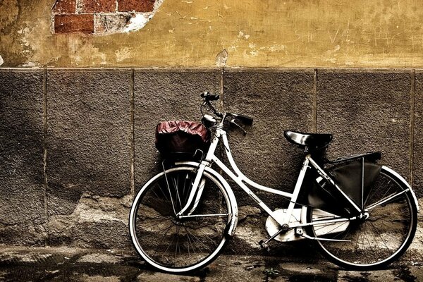 An old bicycle by a shabby wall