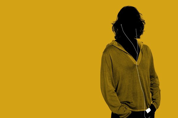 A guy with headphones on a yellow background