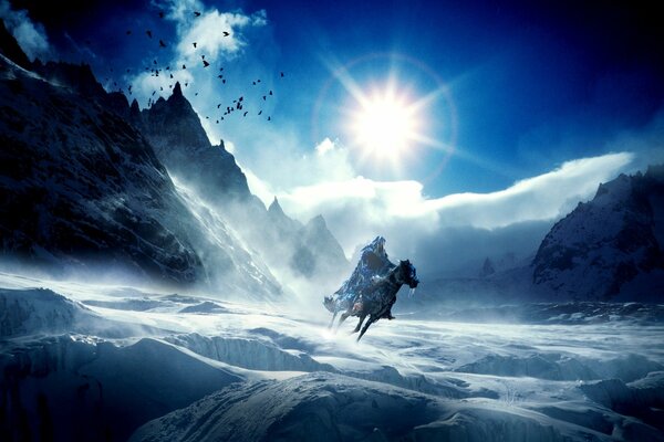 A rider on a horse in the snowy mountains