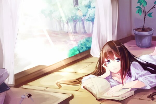 The girl is lying on the floor and reading a book