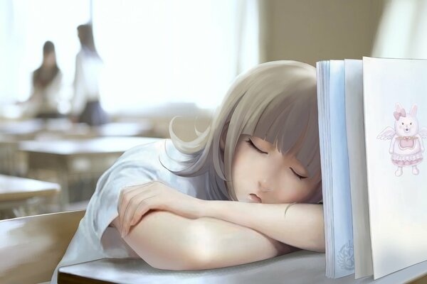 Sleeping girl on the school desk