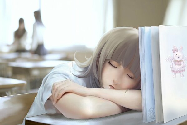 Ragazza addormentata sul banco di scuola