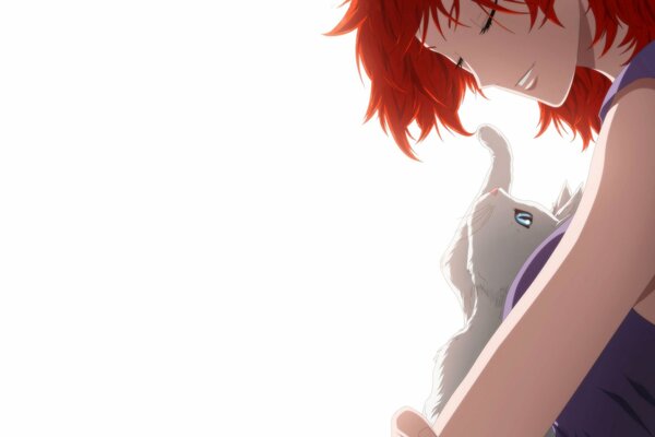 Red-haired girl with a cat on a white background