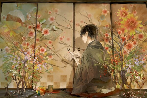 A guy in a kimono sitting in front of a screen