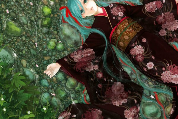 La ragazza in kimono si trova sulle pietre verdi