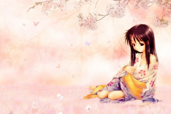 A girl in a kimono under a cherry blossom