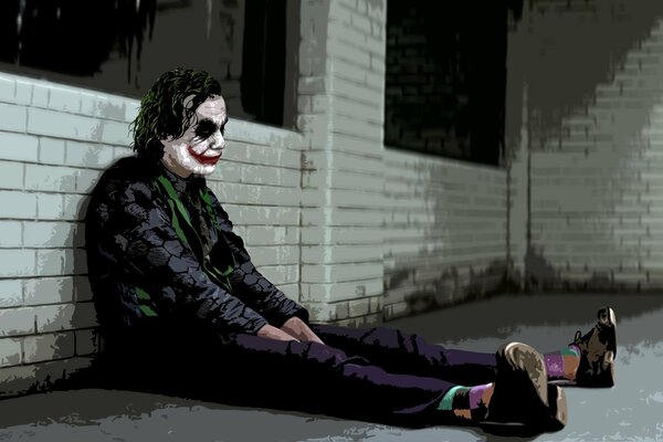 Sad joker is sitting on the floor