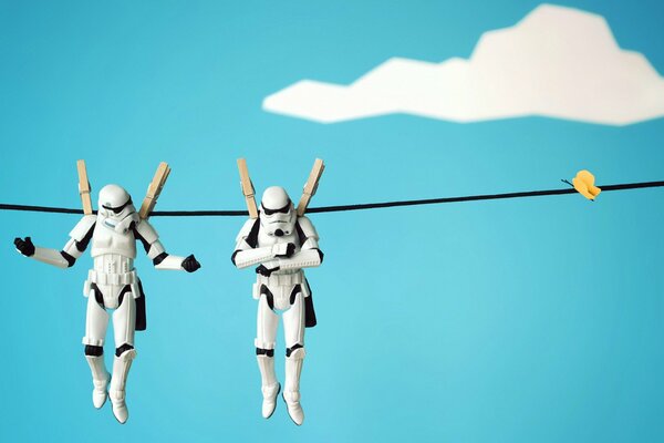 Two Stormtrooper toys hang on a clothesline