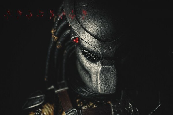 Predator wearing a helmet with symbols on the background